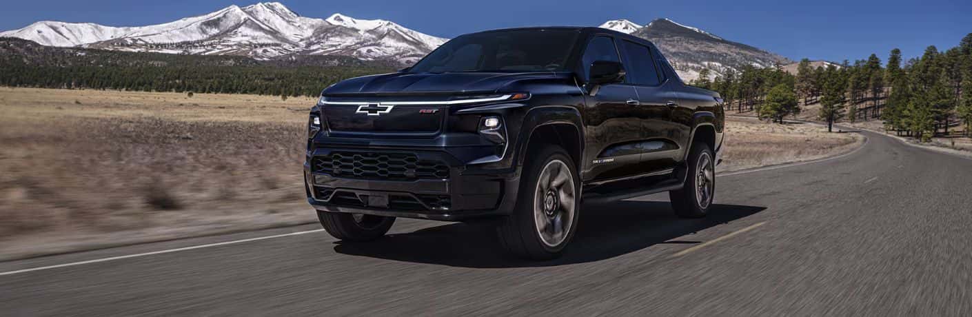 2025 Chevrolet Silverado EV front and side view on a road