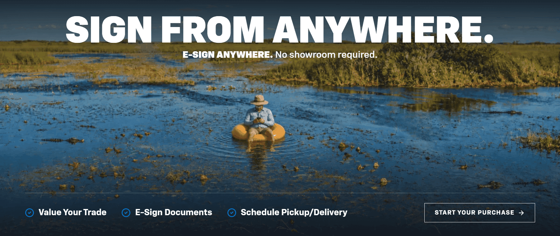 Man sitting in an inner tube in the Florida wetlands signing car purchase documents on his phone - Sign From Anywhere, Start Your Purchase online with Carl Black Chevrolet Orlando