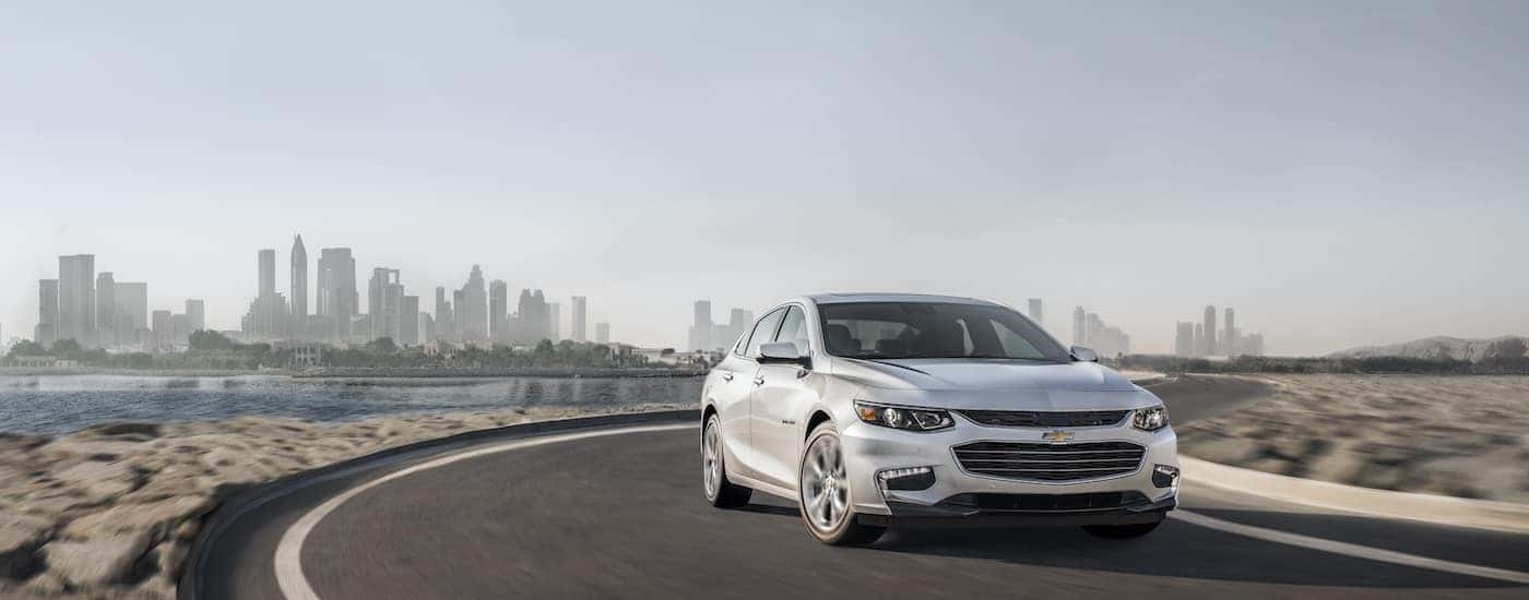 White 2018 Chevy Malibu driving on the road