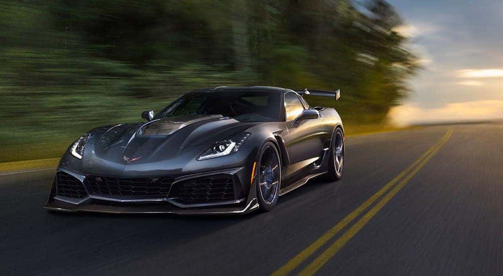 Gray 2019 Chevy Corvette driving on road at dusk