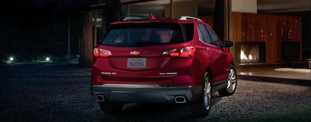 A deep red 2019 Chevy Equinox parked on a dark street