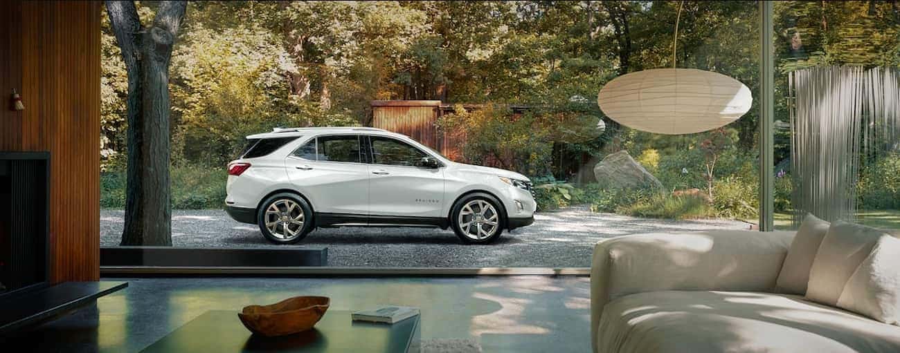 A white 2019 Chevy Equinox parked outside an upscale Nashville home