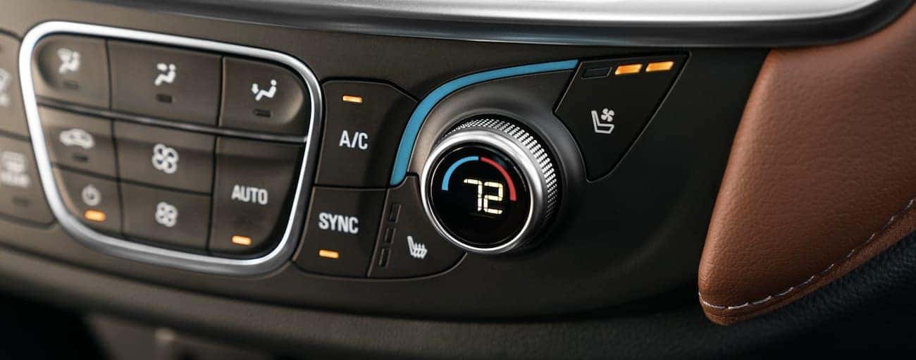 A closeup of the climate control knobs in a Traverse, one of the many things that lead to the victory of 2019 Chevy Traverse vs 2019 Jeep Grand Cherokee