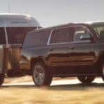 Black 2019 Chevrolet Suburban towing an Airstream trailer
