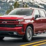 Red 2020 Chevrolet Silverado 3.0L Duramax with snowy mountains in the background