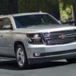 Silver 2020 Chevrolet Tahoe driving on a city street