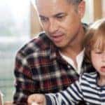 man with two kids learning at home