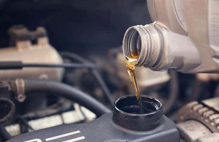 oil being poured into an engine