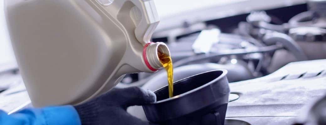 pouring oil into an engine