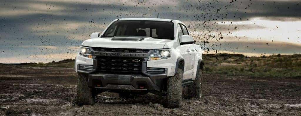 A 2022 Chevy Colorado offroading through mud