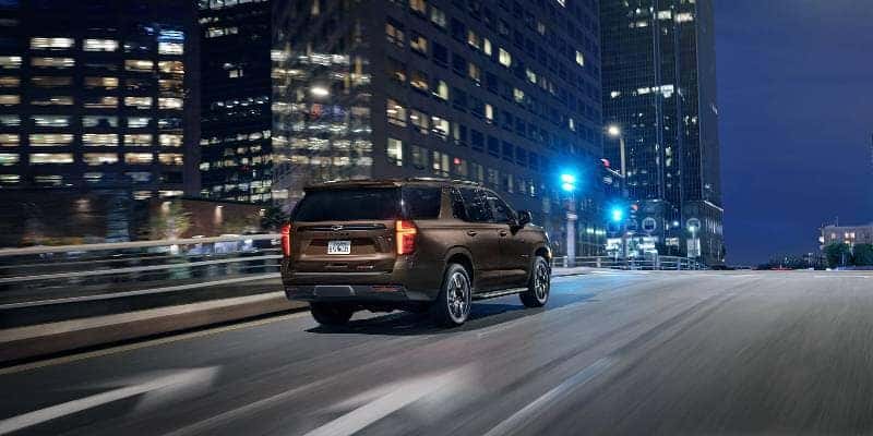 The 2022 Chevy Tahoe driving in an urban landscape.