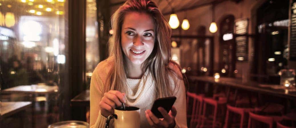 A woman having coffee at one of the top 3 cozy restaurants near Nashville.