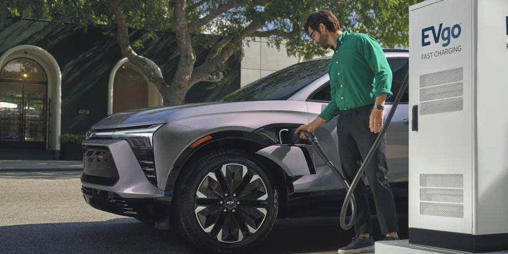 A man charging a 2024 Chevy Blazer EV.