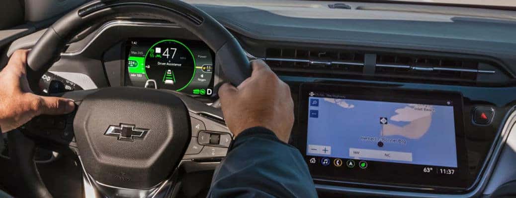 A man using adaptive cruise control in a Chevy vehicle.