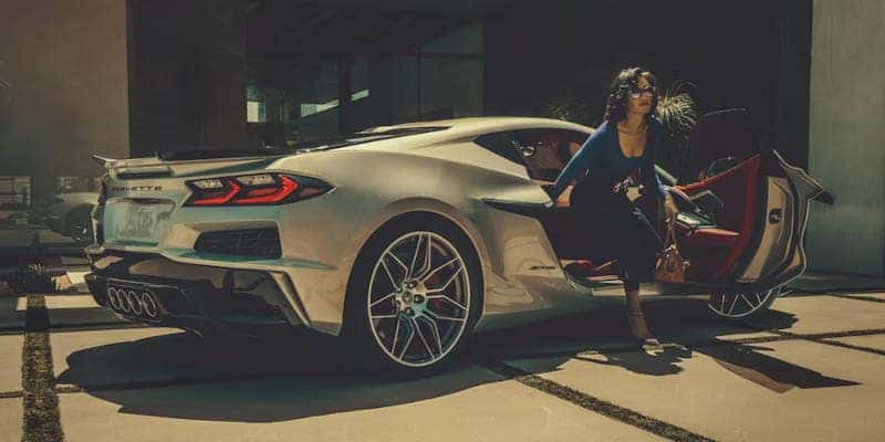A side view of a woman exiting the 2024 Chevy Corvette Z06.