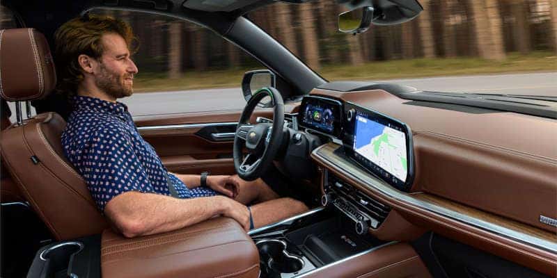 A man using the available hands-free driving feature in the Chevy Suburban.