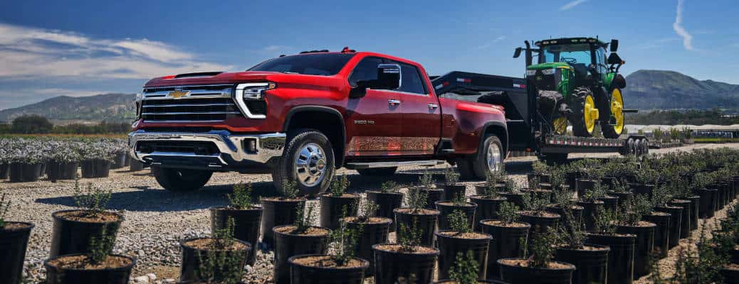 A side view of the 2025 Chevy Silverado 3500 HD hauling a large trailer near Nashville, TN..