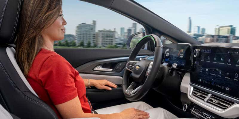 A woman using the self-driving feature in the Chevy Equinox EV.
