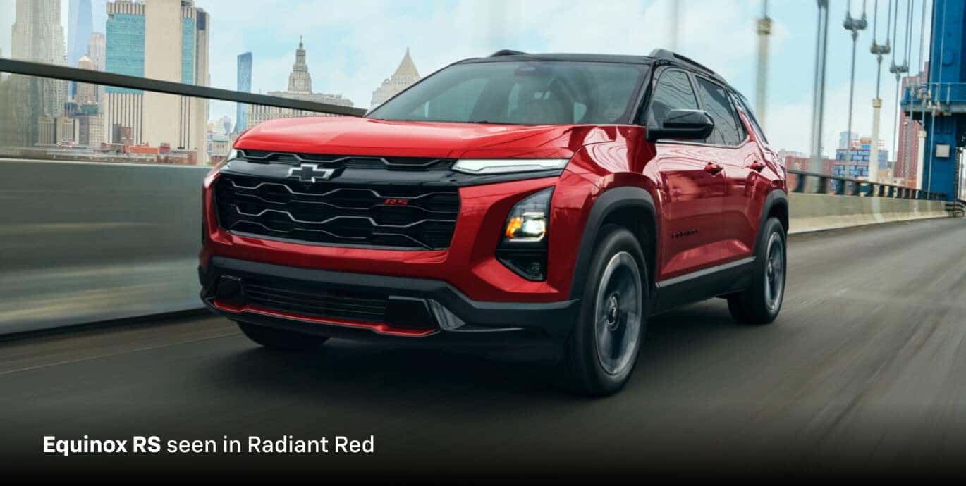 2026 Chevrolet Equinox RS FWD in Radiant Red, front three-quarter view driving across a city bridge.