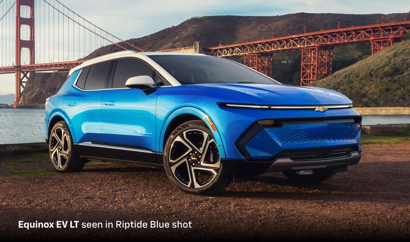 2026 Chevrolet Equinox EV LT FWD in Riptide Blue, front three-quarter view by the Golden Gate Bridge.