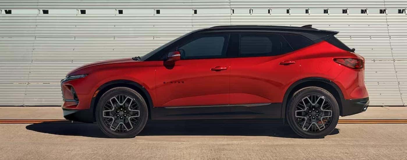 A red 2024 Chevy Blazer RS is shown parked near bleachers.