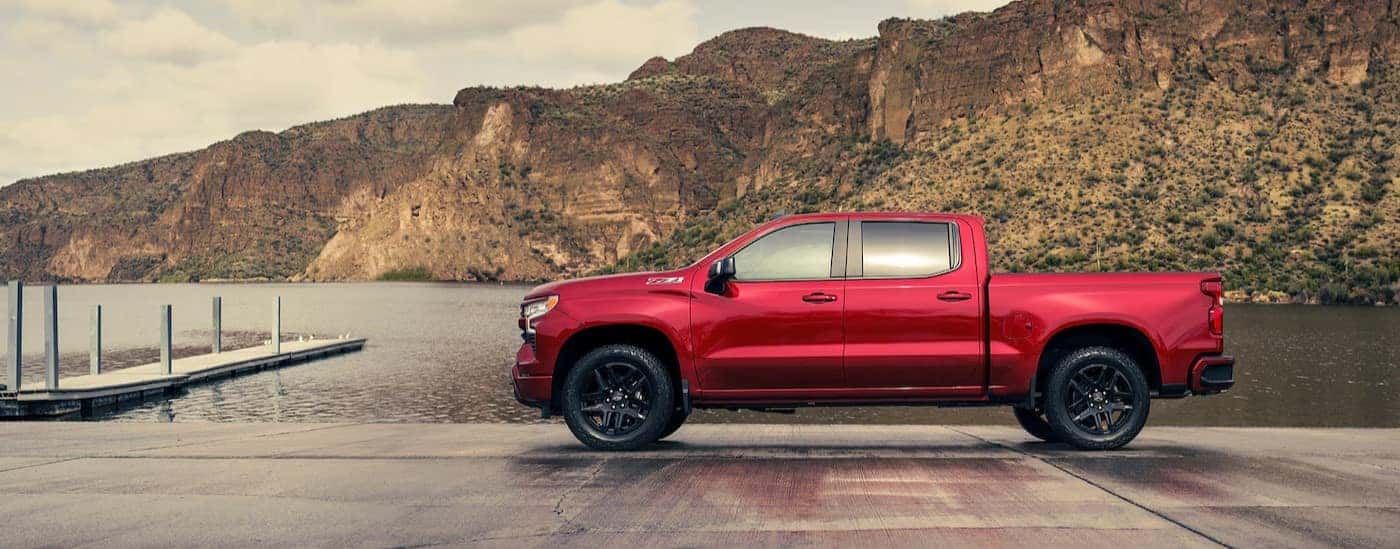 A red 2025 Chevy Silverado 1500 Z71 parked near a lake.
