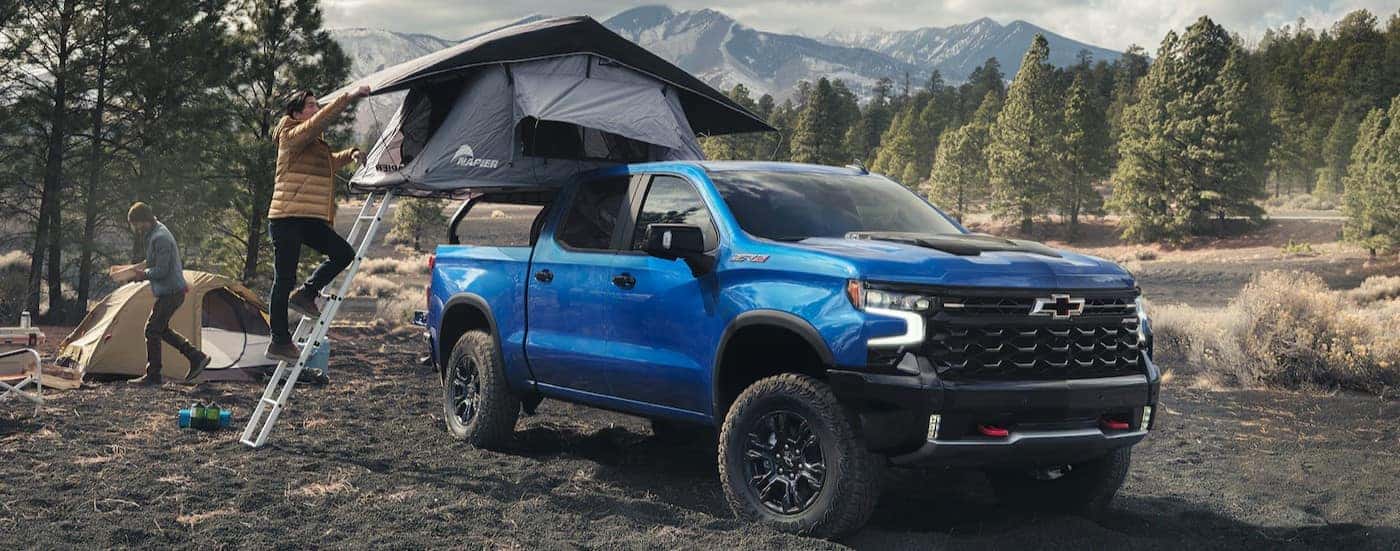 A blue 2025 Chevy Silverado 1500 ZR2 parked on a campsite.