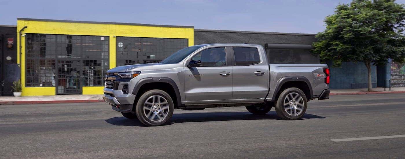 A silver 2025 Chevy Colorado Z71 is shown from the side after leaving a Chevy dealer.