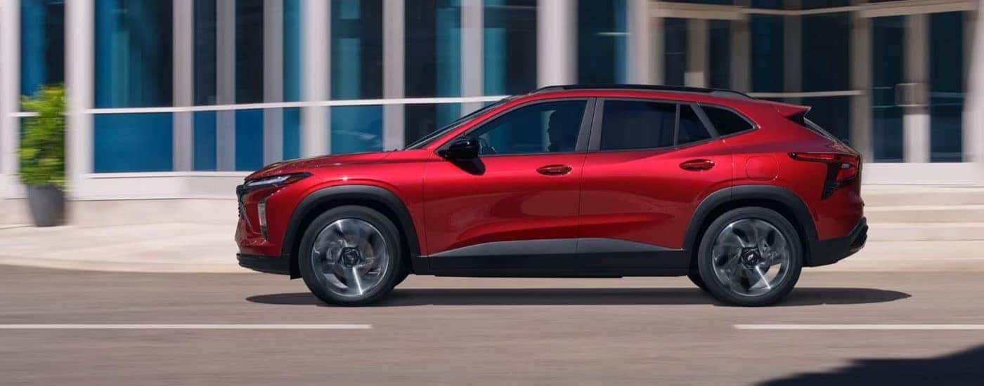 A red 2024 Chevy Trax RS is shown driving to a Chevrolet dealer near Hartford.