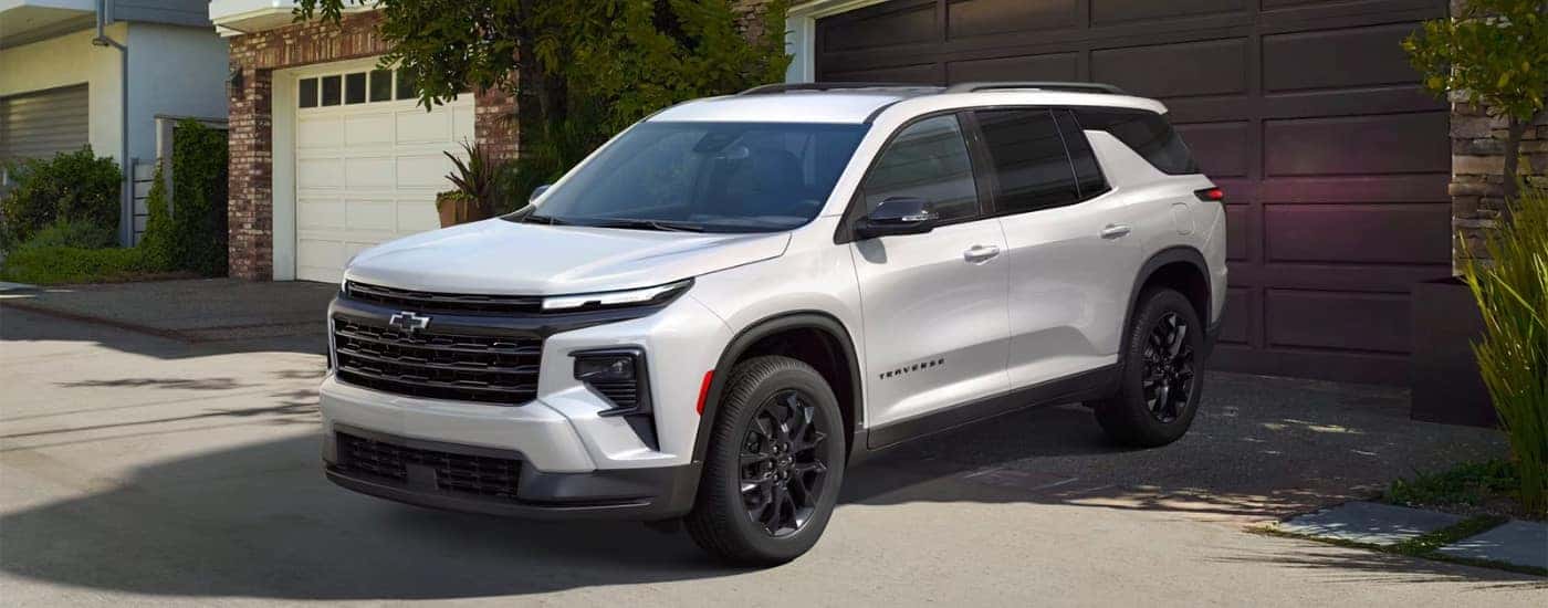 A white 2025 Chevy Travers Traverse Midnight Sport Edition is shown parked after visiting a Chevy dealer near Manchester.