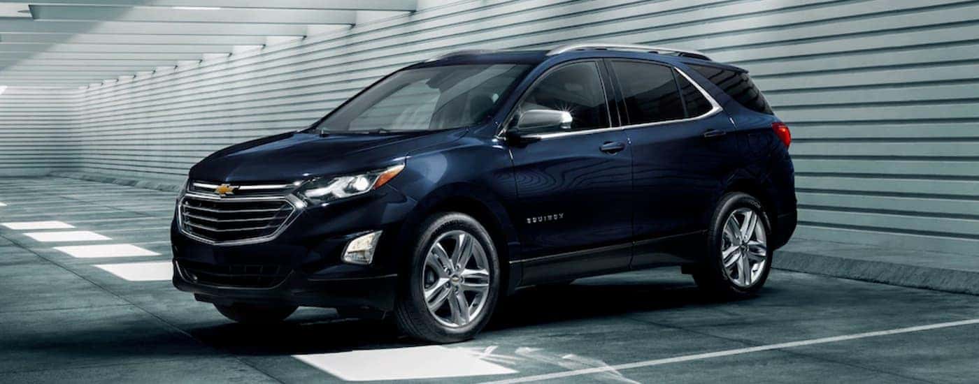 A dark blue 2020 Chevy Equinox parked in a parking garage near a dealer with used Chevrolet for sale near Manchester.