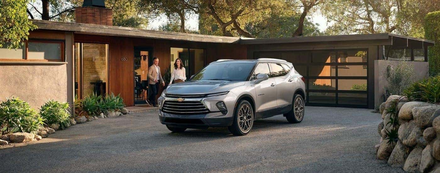 A silver 2025 Chevy Blazer parked in a gravel driveway