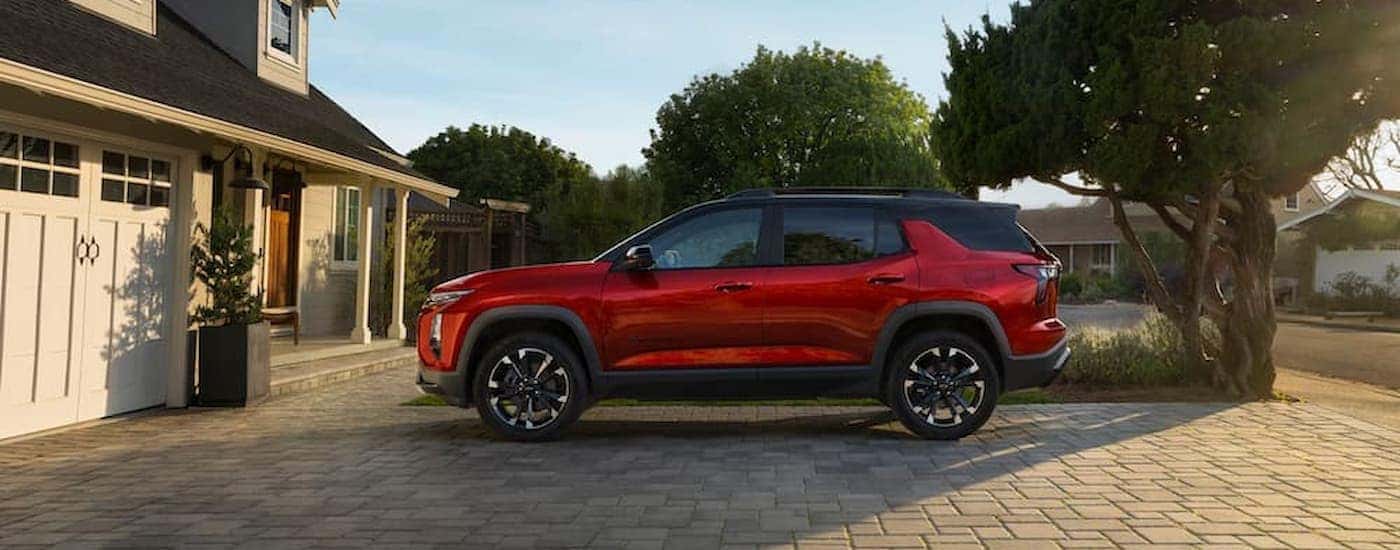 A red 2026 Chevy Equinox parked in a driveway