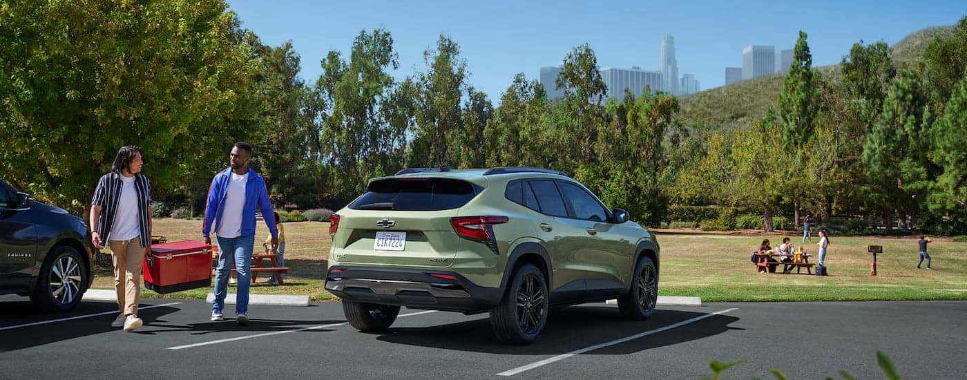 Green 2025 Chevy Trax ACTIV parked in a parking lot.