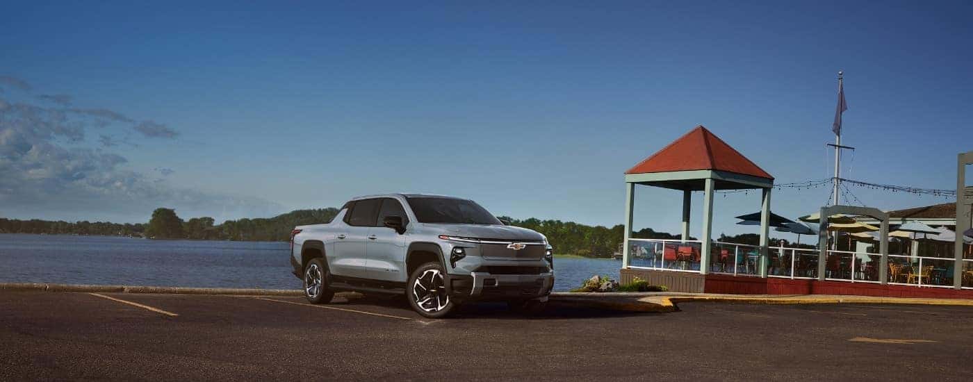 A blue 2025 Chevy Silverado EV from the front at at an angle.