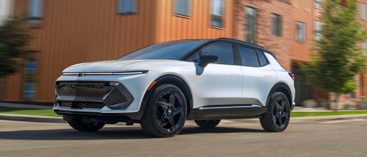 A white 2025 Chevy Equinox EV from the side.
