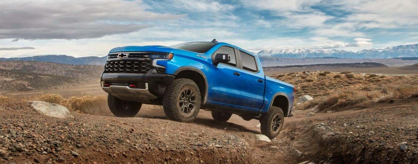 Blue 2025 Chevy Silverado 1500 ZR2 parked off-road.