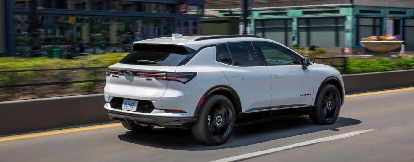 A white 2025 Chevy Equinox EV from the rear at an angle.