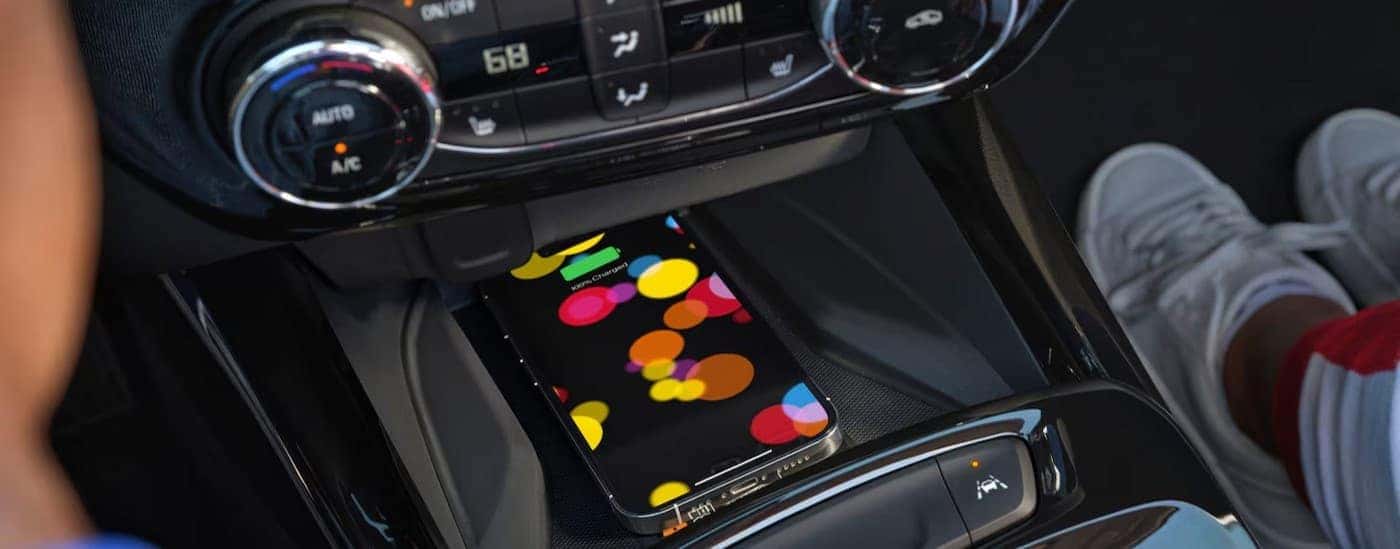 Cell phone charging in the center console in a 2026 Chevy Trax for sale near Hartford.