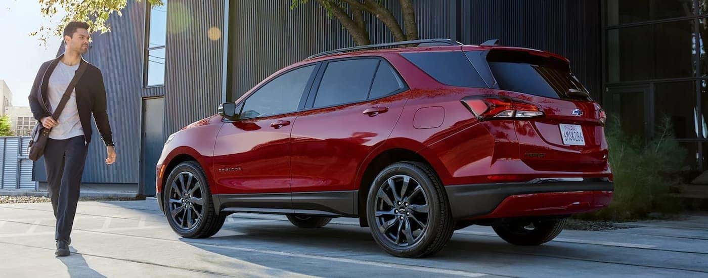 Red 2026 Chevy Equinox parked with a person walking away