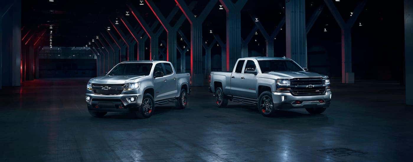 2018 Chevy Silverado and Colorado parked under an overhand