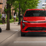 Red 2026 Chevy Bolt for sale parked on the street