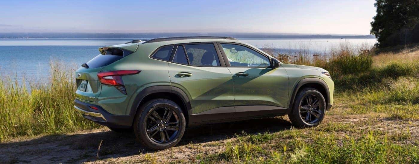 A green 2026 Chevy Trax for sale near South Windsor from the side.