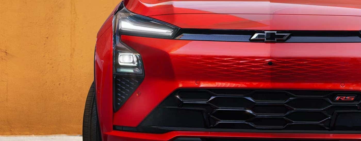 Front grille of a red 2027 Chevy Bolt RS parked for sale near East Hartford