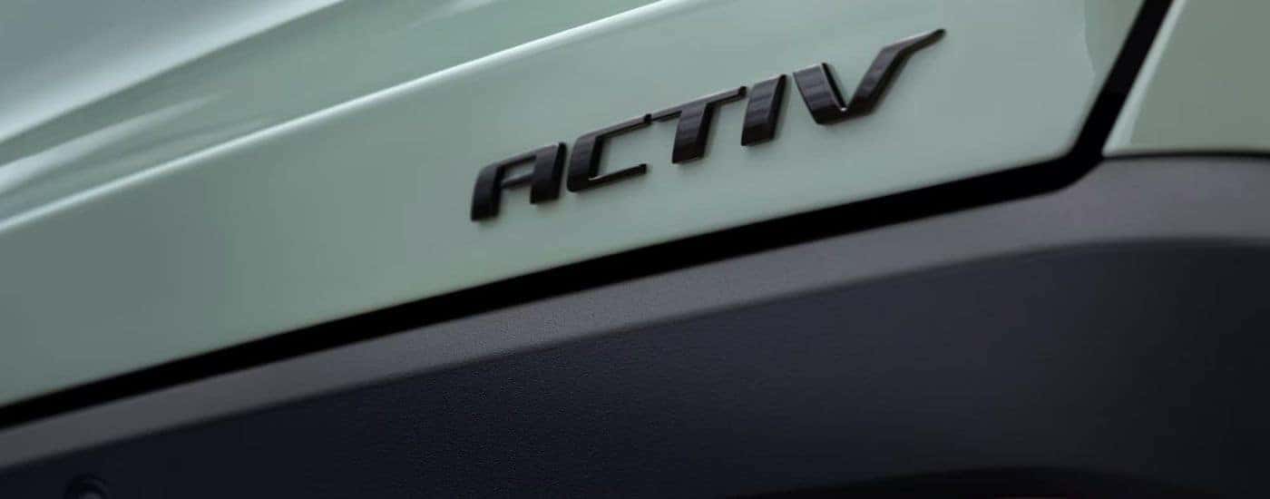 Black ACTIV badge on the trunk of a green 2026 Chevy Equinox ACTIV