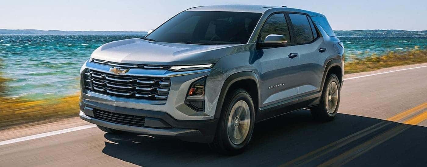 Silver 2026 Chevy Equinox driving along a coast