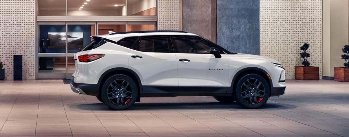 A white 2023 Chevy Blazer shown from the side parked on a street.