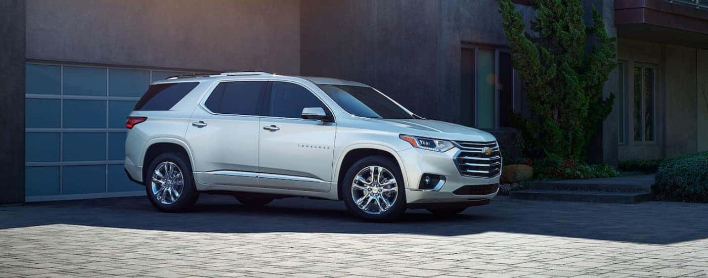 A silver 2019 Chevy Traverse parked in front of a garage.