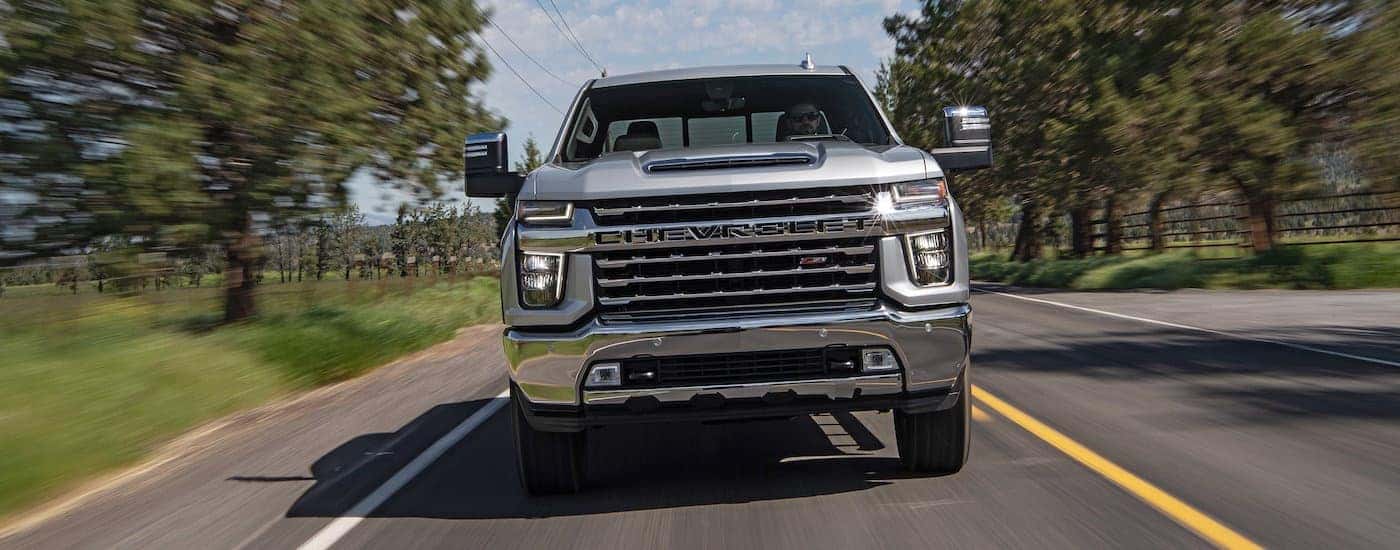 A silver 2020 Chevy Silverado 2500 HD Z71 shown head-on driving a paved road.