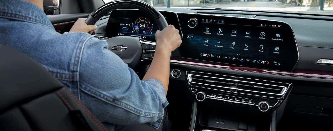 A person driving in a 2026 Chevy Traverse.